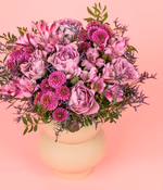 Round bouquet of lavender, lilac roses, purple alstroemeria, purple spray chrysanthemums and purple chrysanthemums