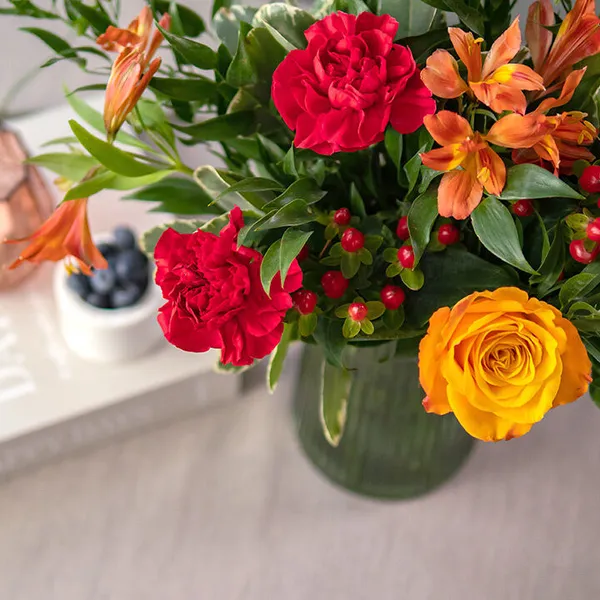 red and orange flowers in a vase