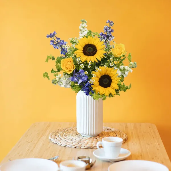 Sunflower bouquet in a vase on a dining table