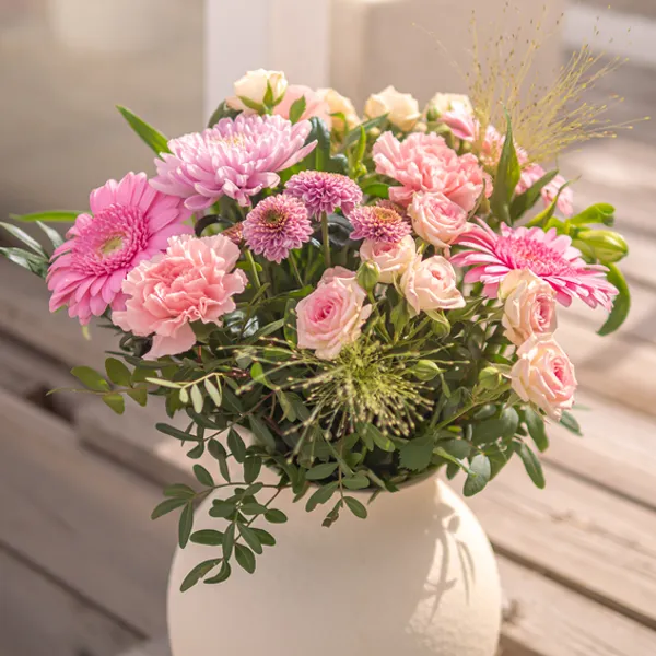 A pink bouquet of pink gerberas, roses and carnations