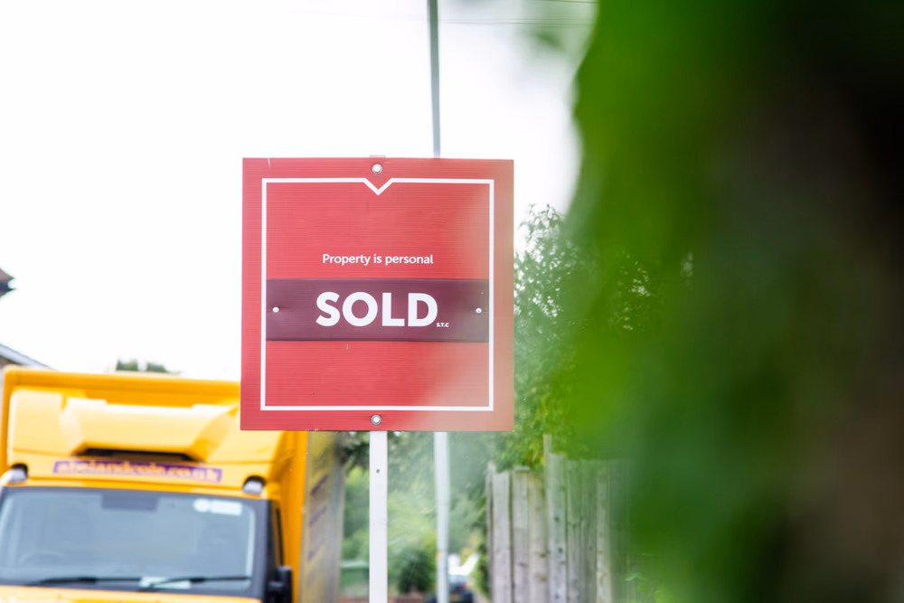 Red sold house sign