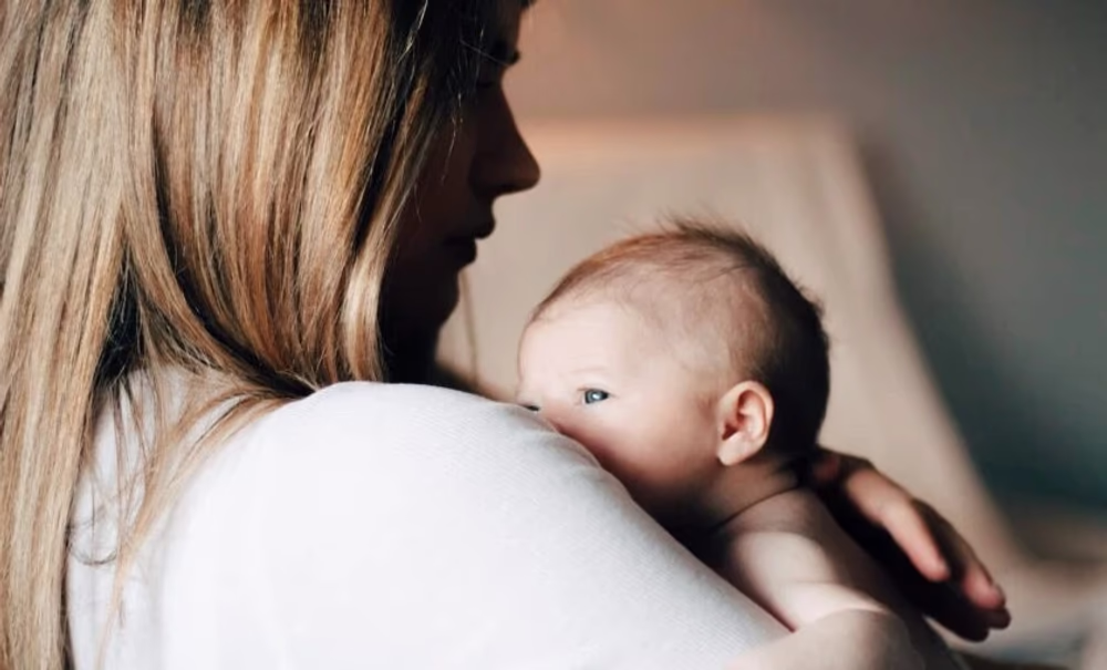 Woman holding a newborn baby