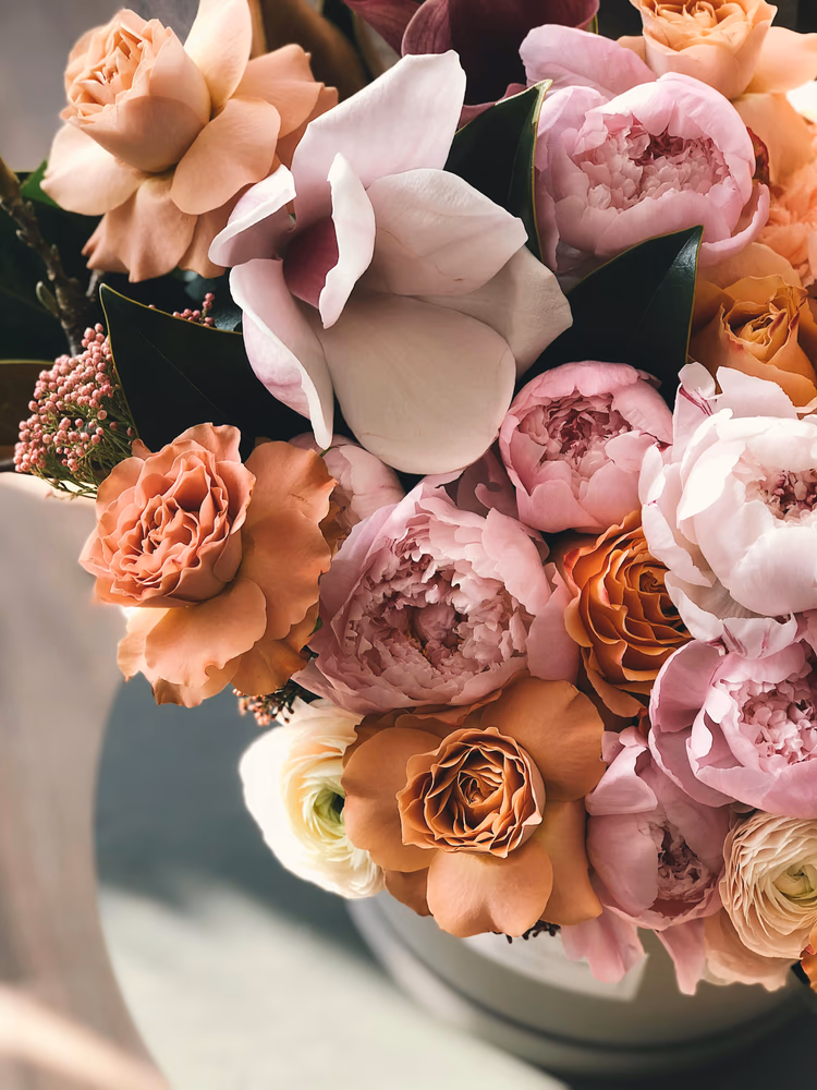 Birds eye view of a bouquet of soft peach and pink flowers